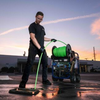 Sewer line cleaner professional using water jetting machine for cleaning