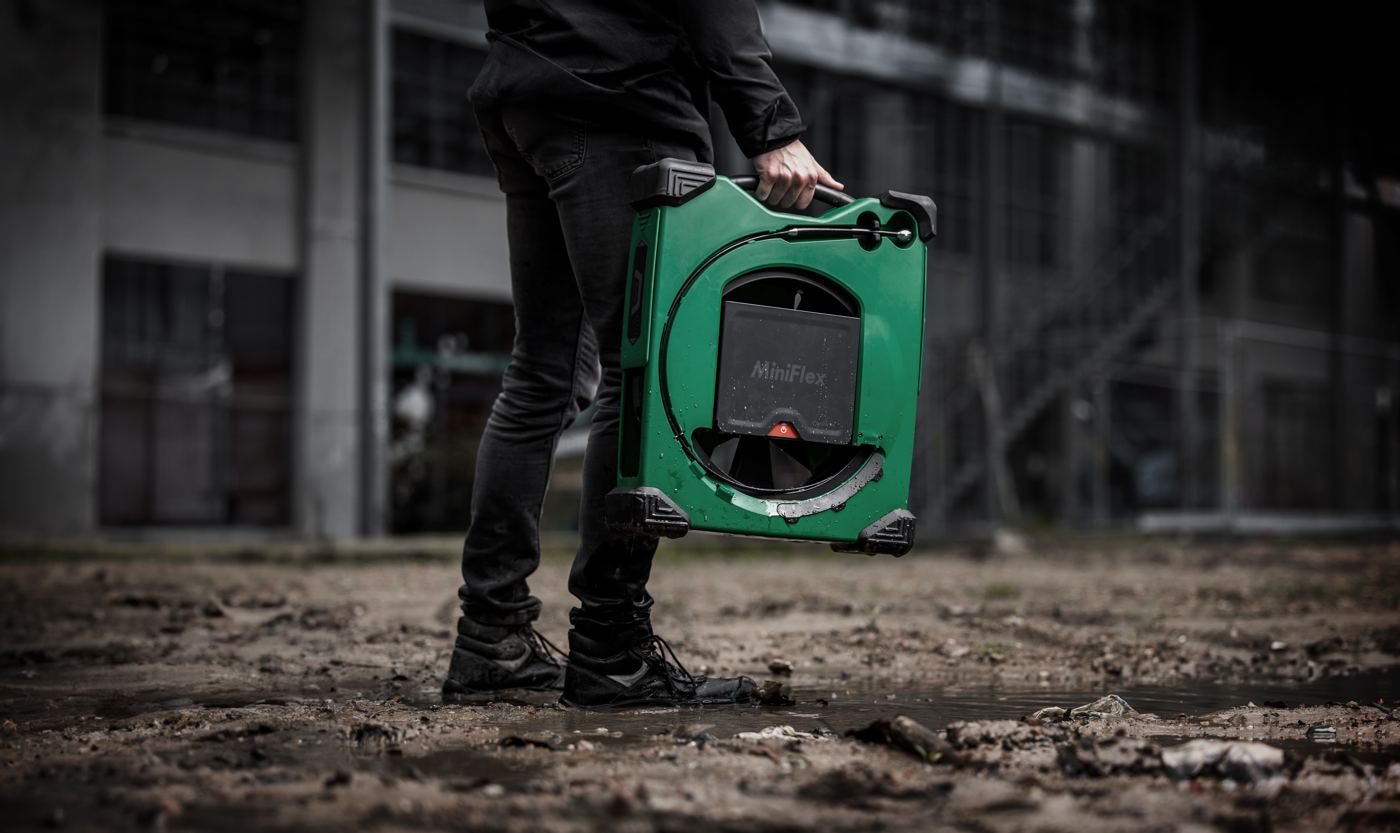 Plumber carrying the MiniFlex across a job site