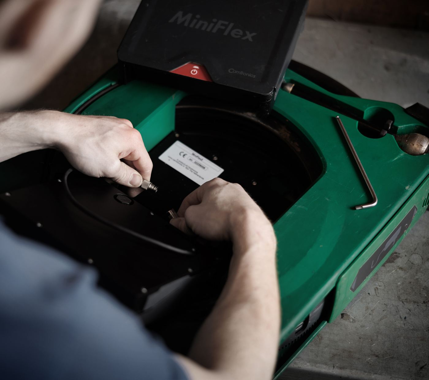 Technician swapping a part inside the MiniFlex